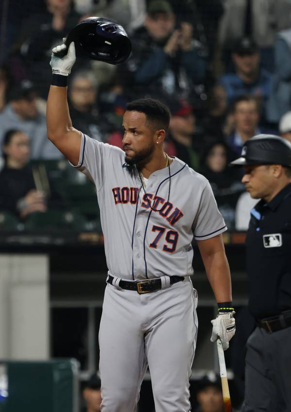Astros first baseman José Abreu takes off his batting helmet to acknowledge fans as they applaud in their second inning against the White Sox at Guaranteed Rate Field on May 12, 2023.