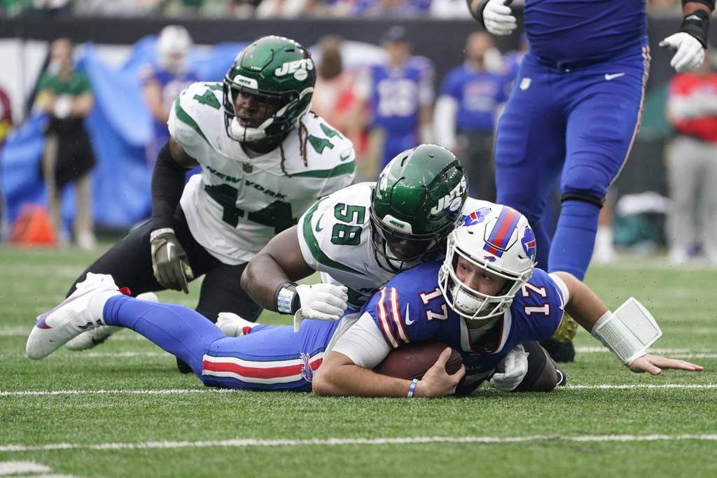 Jets defensive end Carl Lawson (58) tackles Bills quarterback Josh Allen (17) on Nov. 6, 2022, in East Rutherford, N.J.