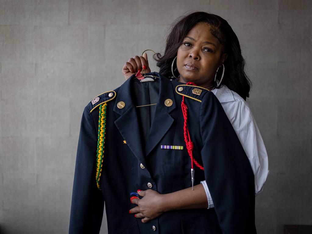 Tawana Washington holds the JROTC uniform of her daughter, Astarte Washington.