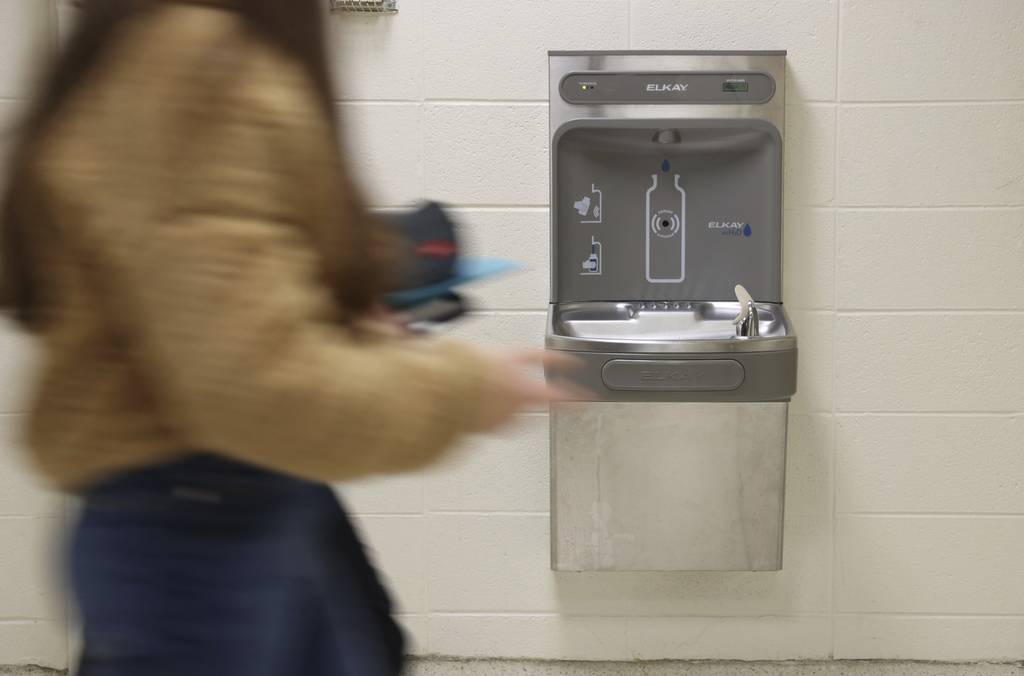 Students pass a drinking fountain and bottle filling station at Washburne School in Winnetka. The district said it shut down or curbed the use of any fixtures where elevated lead levels were detected, then budgeted millions for remediation.