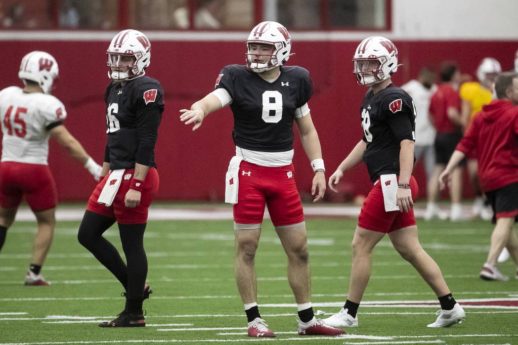 Wisconsin quarterbacks Myles Burkett (16), Tanner Mordecai (8) and Braedyn Locke (18) participate during spring practice at the McClain Center in Madison, Wis., on March 30, 2023.