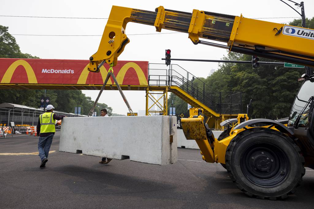 A concrete barrier is moved at the corner of East Jackson Drive and South Columbus Drive near Turn 12 on June 27, 2023, for the upcoming NASCAR Chicago Street Race.