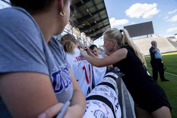 Washington Spirit midfielder Chloe Ricketts signs autographs for fans following an NWSL soccer match against the San Diego Wave on May 6, 2023.