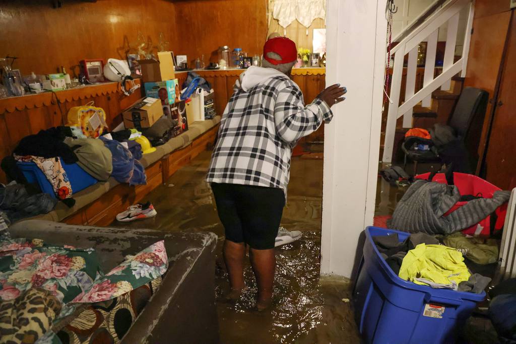 Shirley Howard stands in her flooded basement in Chicago's Austin neighborhood on July 2, 2023.