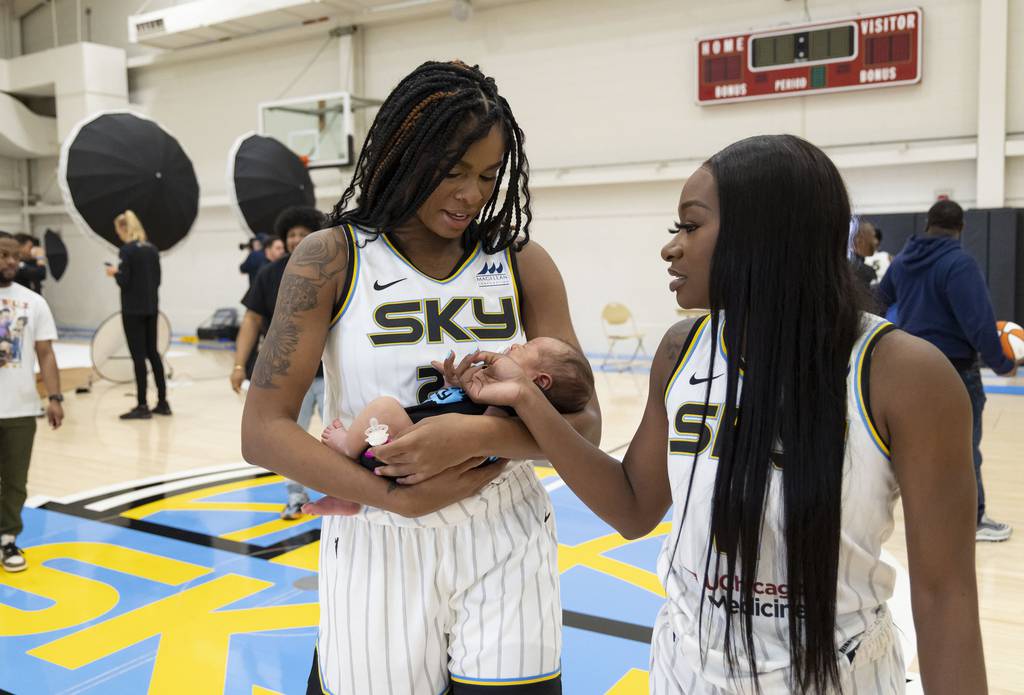Chicago Sky forward Ruthy Hebard holds her baby Xzavier with teammate Dana Evans on May 10, 2023, on media day at the team’s practice facility.