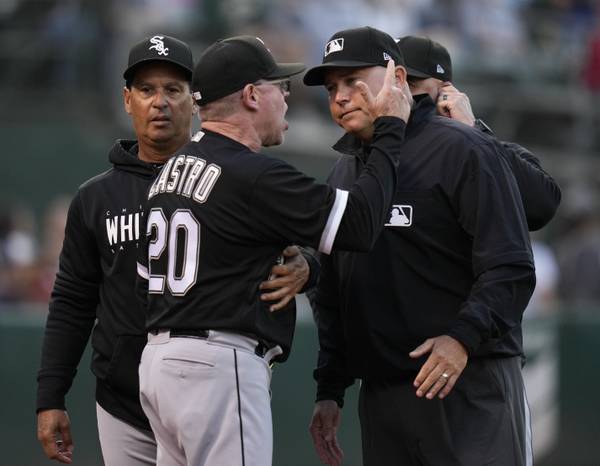 White Sox hitting coach José Castro speaks to first base umpire Mark Carlson after he was ejected by home plate umpire Tripp Gibson at the end of the fourth inning on June 30, 2023.