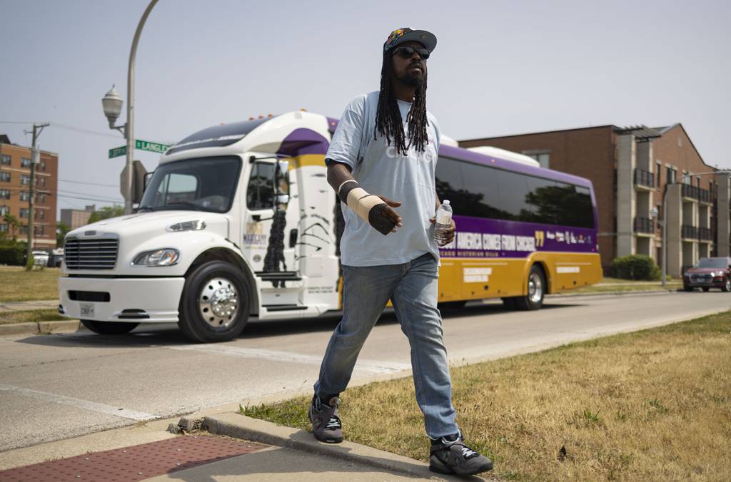 Shermann “Dilla” Thomas' walks near his bus during a Mahogany Bus Tour on June 18, 2023.
