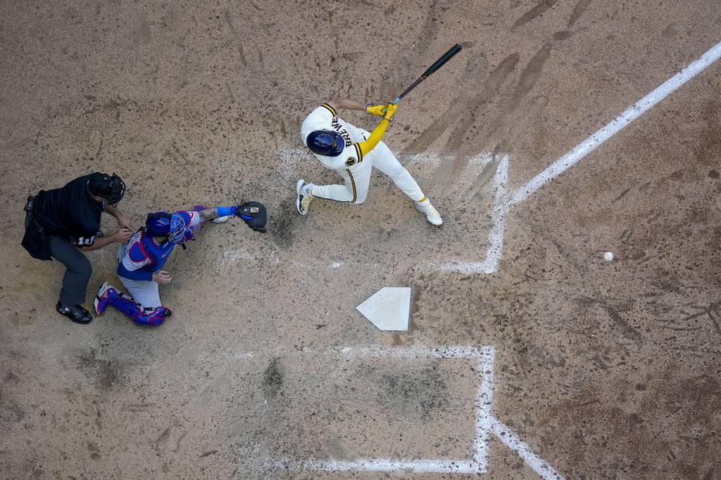 The Brewers' Willy Adames hits an RBI single during the eighth inning against the Cubs on July 3 in Milwaukee.