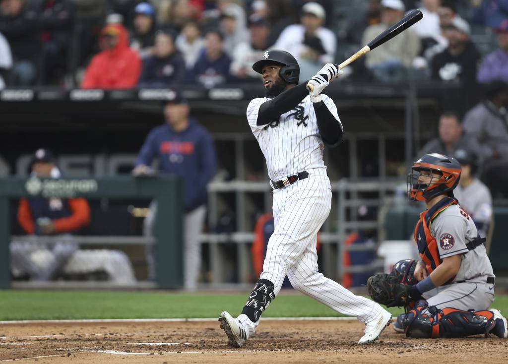 White Sox center fielder Luis Robert Jr. watches the flight of his solo home run against the Astros at Guaranteed Rate Field on May 13, 2023.