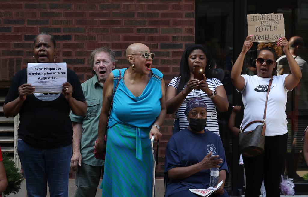 Residents and housing advocates, including Claudette Boisseau, center, gather for a rally and protest in the courtyard of an apartment building in the 10300 block of South Walden Parkway on July 19, 2023, in Chicago. Residents of the building and nearby apartments, managed by Levav Properties, have been told they have until the end of September to move out of their units. Boisseau said she has lived in her space for 20 years.