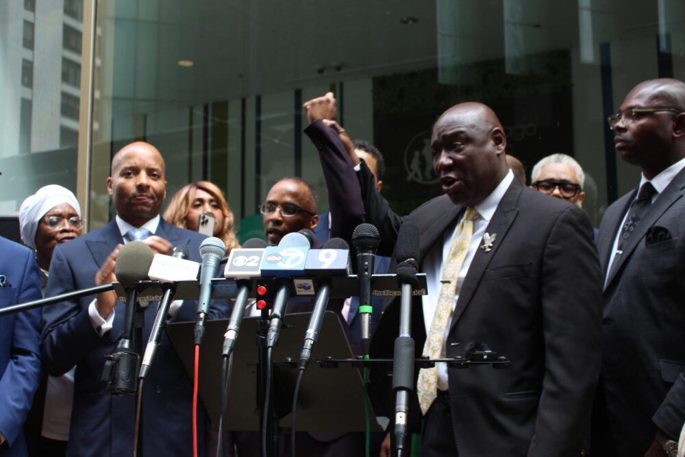 BEN CRUMP HOLDS UP MR. ABDUL MUHAMMADs HAND IN VICTORY SIGN scaled