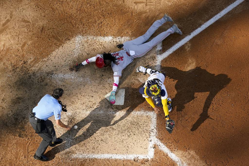 The Reds' Elly De La Cruz steals home with Brewers catcher William Contreras covering during the seventh inning Saturday, July 8, 2023, in Milwaukee.