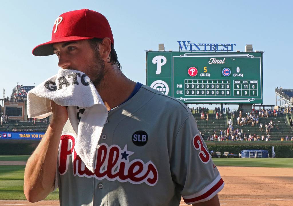 Phillies pitcher Cole Hamels wipes his face after pitching a no-hitter against the Cubs on July 25, 2015, at Wrigley Field. It was the first no-hitter against the Cubs since Sandy Koufax’s perfect game at Dodger Stadium in 1965, a span of 7,920 games.