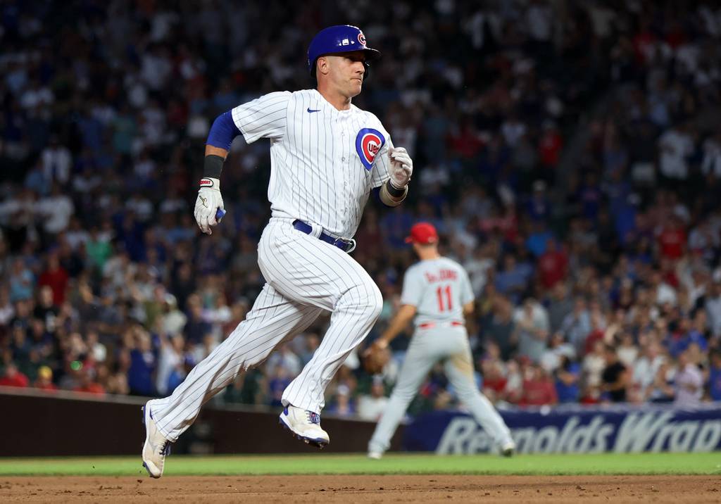 Cubs catcher Yan Gomes rounds the bases on his a run-scoring triple in the fourth inning against the Cardinals on Thursday at Wrigley Field.