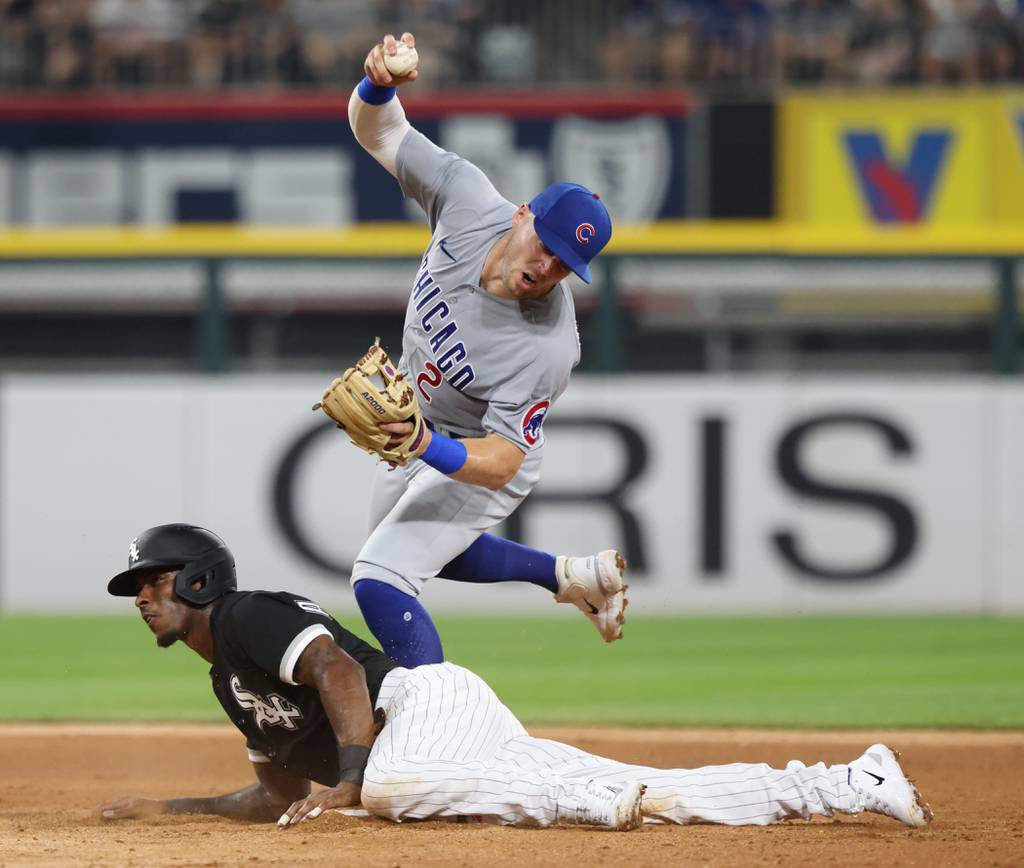 White Sox shortstop Tim Anderson beats the throw to Cubs second baseman Nico Hoerner as Hoerner stops himself from throwing to first base in the fourth inning at Guaranteed Rate Field on July 26, 2023.