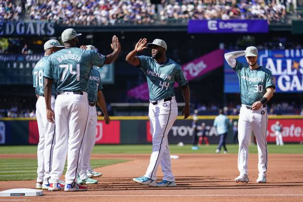 The American League's Julio Rodríguez of the Mariners (44) and Kyle Tucker of the Astros (30) greet teammates before the MLB All-Star Game on Tuesday, July 11, 2023, in Seattle.
