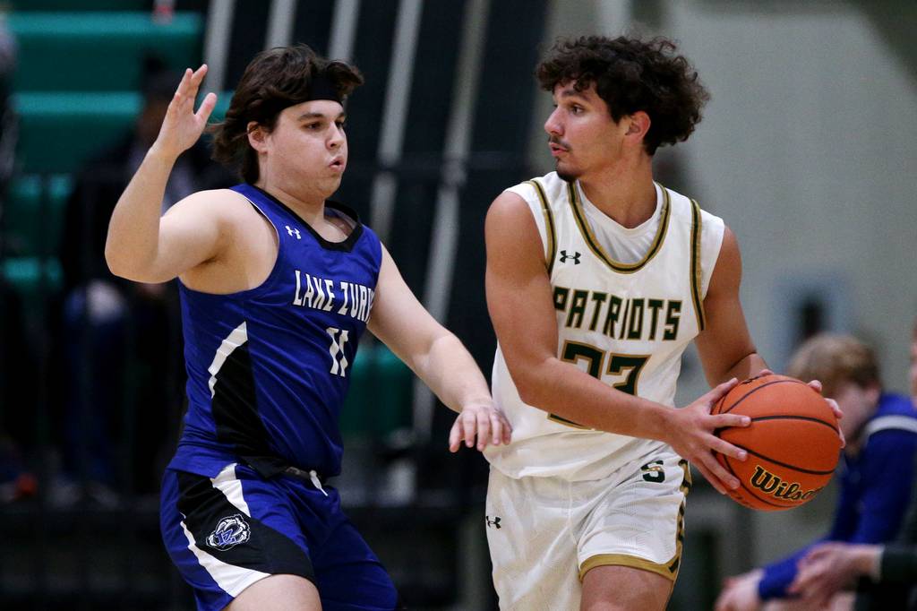 Lake Zurich’s Jonathan Fleaka, left, defends against Stevenson’s Brandon Sorokin during a game in Lincolnshire on Friday, Jan. 20, 2023.