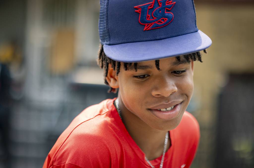 Paris Head, 12, smiles during a block party on his Humboldt Park street.