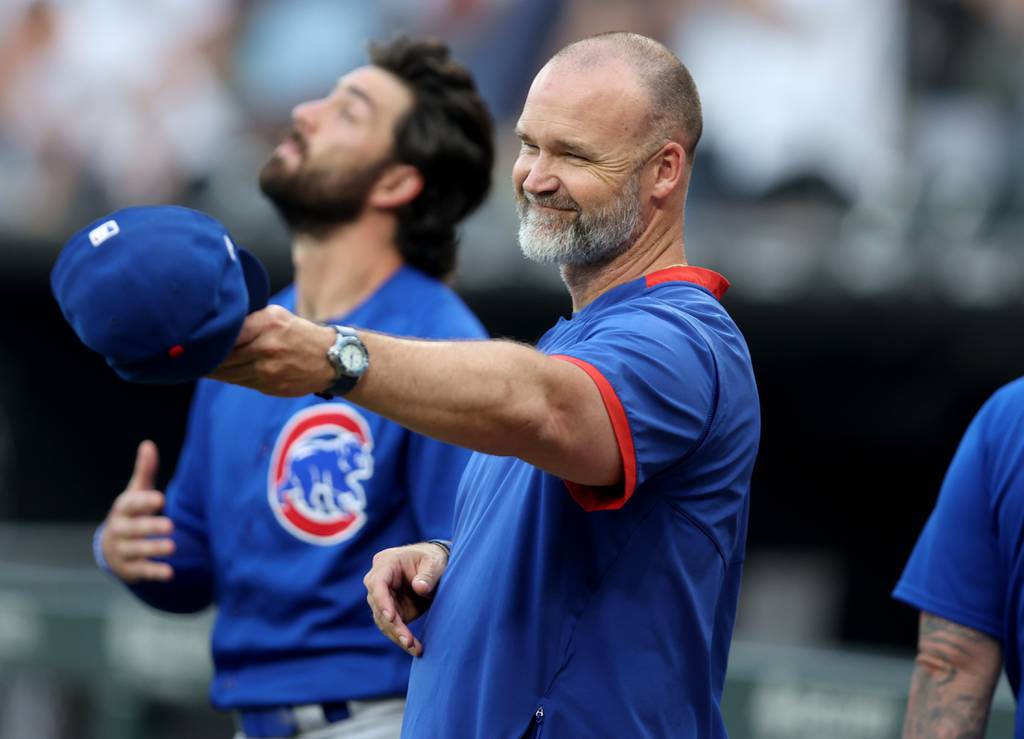 Cubs manager David Ross shares a smile with somebody on the White Sox after the national anthem before a game Tuesday at Guaranteed Rate Field. 