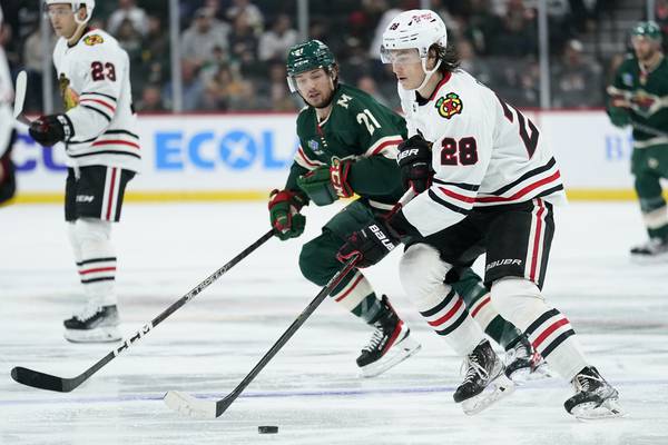 Blackhawks center Colton Dach (28) skates with the puck in a preseason game against the Wild on Oct. 6, 2022, in St. Paul, Minn.