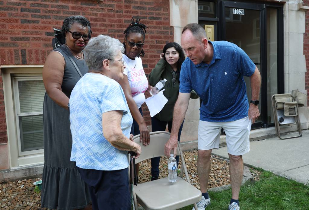Ald. Matt O'Shea, 19th, greets a resident after a rally and protest in the courtyard of an apartment building in the 10300 block of South Walden Parkway on July 19, 2023, in Chicago.