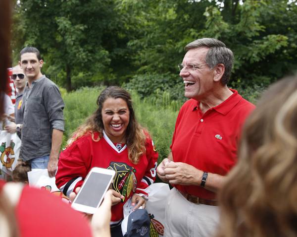 Danielle Pape, 22, of Chicago, laughs with Rocky Wirtz and other guests after having their photo taken with the Stanley Cup at Wirtz's home in Winnetka on August 9, 2015.