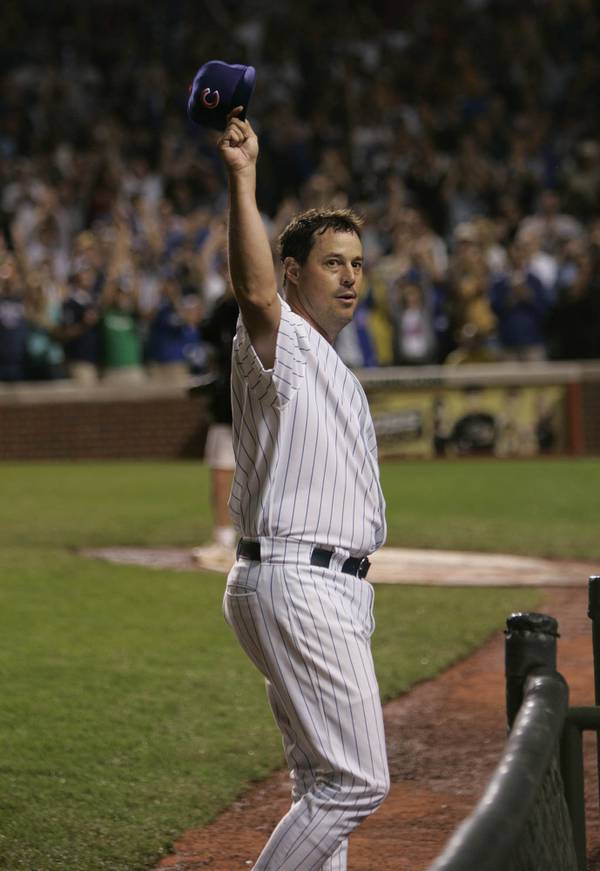 The Cubs' Greg Maddux tips his hat to the Wrigley Field crowd after reaching 3,000 strikeouts in the third inning against the Giants' Omar Vizquel on July 26, 2005.