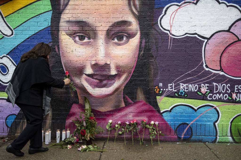 Community members leave flowers for Melissa Ortega on Jan. 22, 2023, in front of a memorial near West 26th Street in Little Village, one year after the 8-year-old was shot and killed while walking with her mother.