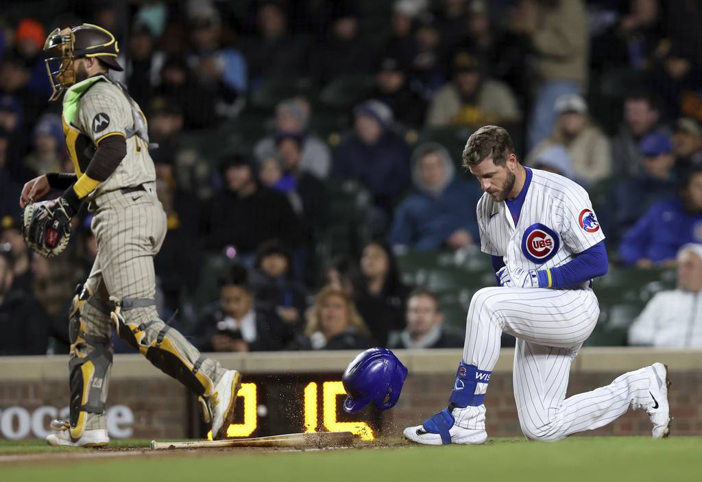 Cubs third baseman Patrick Wisdom throws his helmet to the ground after striking out to end the fifth inning against the Padres on April 25 at Wrigley Field.
