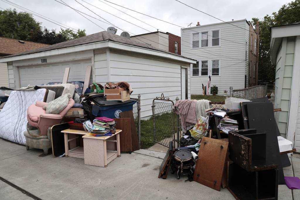 Food-damaged furniture sits in the alley along the 2400 block of South 57th Avenue in Cicero on July 6, 2023, following heavy rains in the area.