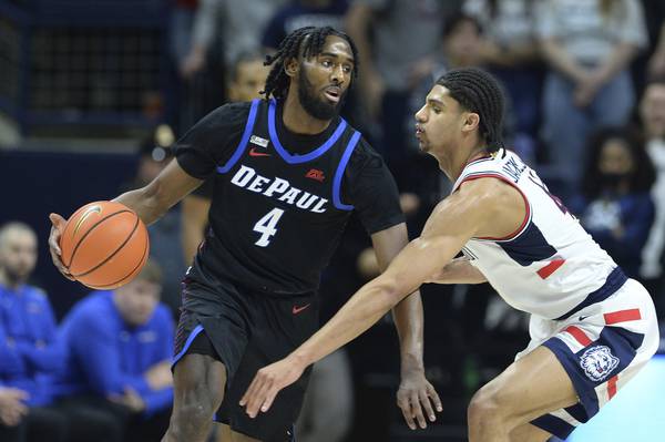 Connecticut's Andre Jackson (44) reaches in on DePaul's Javon Freeman-Liberty in the second half on March 5, 2022, at Gampel Pavilion in Storrs, Conn.