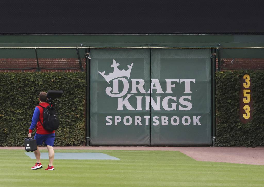 A DraftKings Sportsbook logo is posted on the right field wall of Wrigley Field before a game between the Chicago Cubs and Philadelphia Phillies Tuesday, Sept. 27, 2022, in Chicago. (John J. Kim/Chicago Tribune)