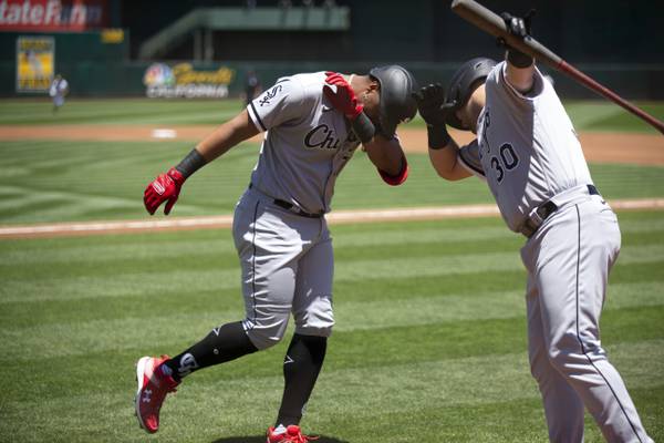 The White Sox's Eloy Jiménez, left, celebrates with Jake Burger after his solo home run during the second inning Saturday, July 1, 2023, in Oakland, Calif.