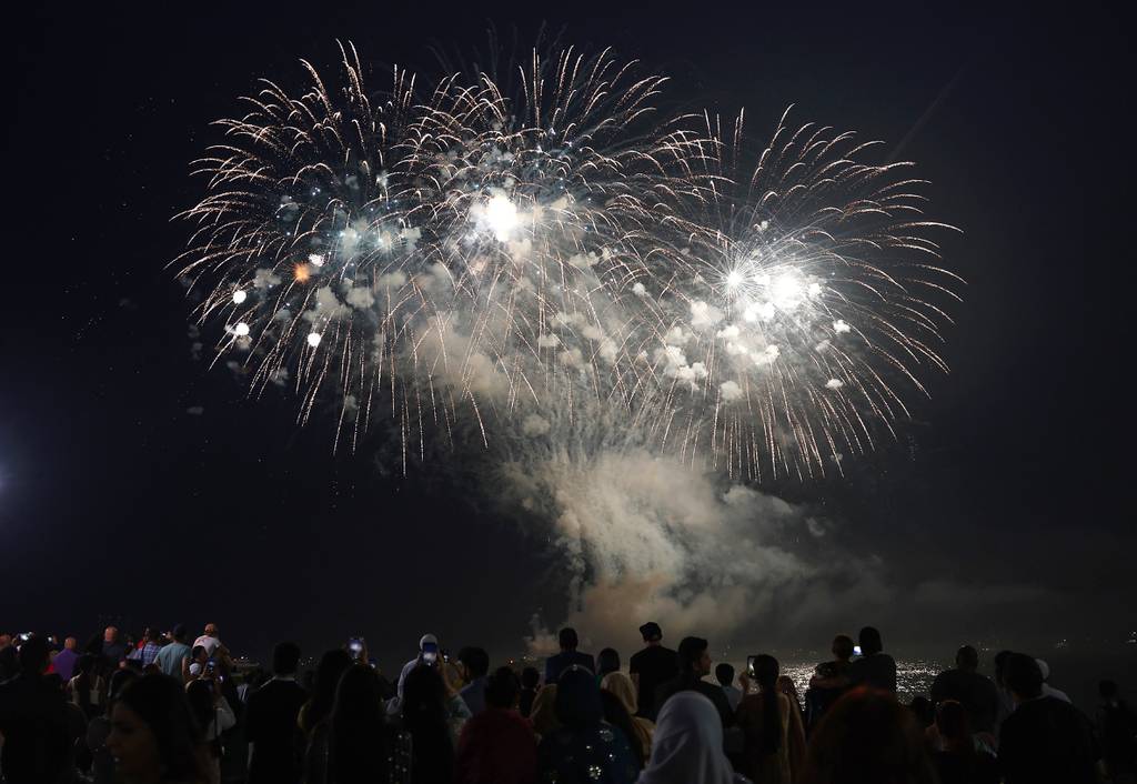 People watch from Navy Pier in Chicago as fireworks are set off on July 1, 2023, to celebrate the Fourth of July weekend.  