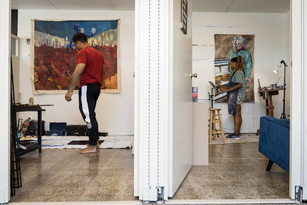 Artists Anthony Olusina Schleicher and Kristen C. Williams work in their studios at Artists on the 9 on July 10, 2023.   