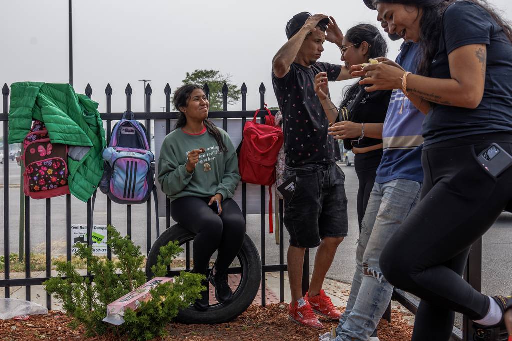 From left, Alexa Ovalles, Yorman Bravo, Julianna Ovalles, Alejandro Zavala, and Patricia Moyeja, all of Venezuela, wait for work in the Home Depot parking lot along West 87th Street  in Chicago on June 28, 2023.