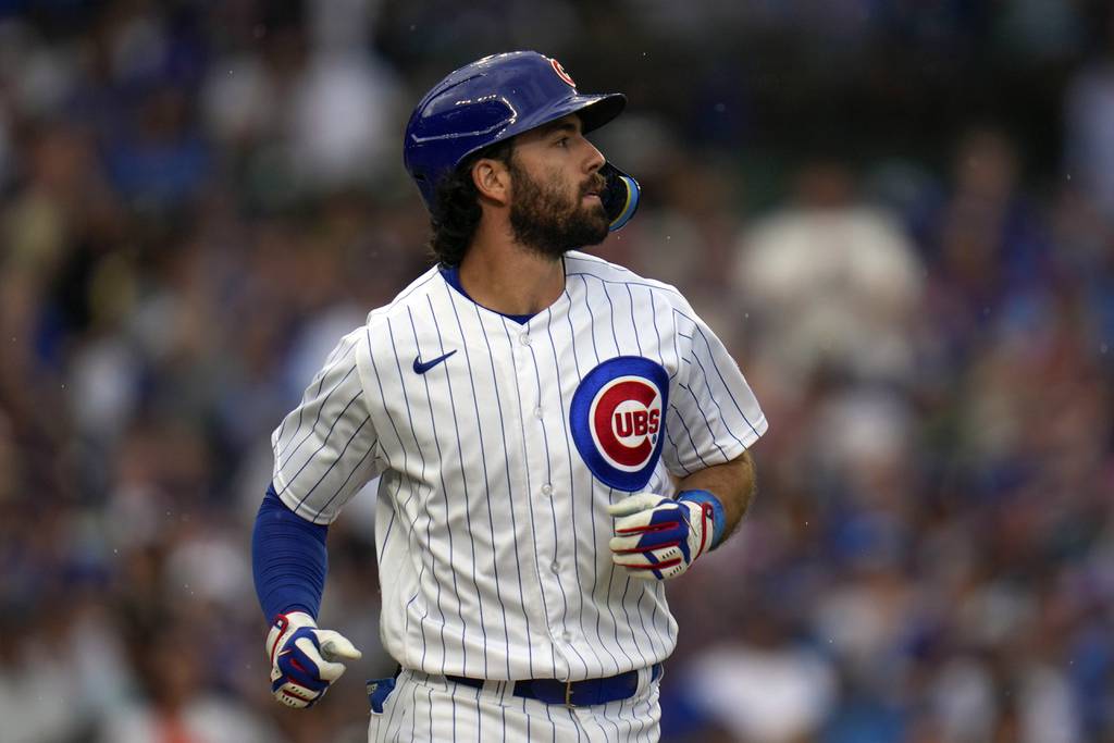 Cubs shortstop Dansby Swanson heads to first after he was hit by a pitch in the sixth inning against the Cardinals on Saturday at Wrigley Field. 