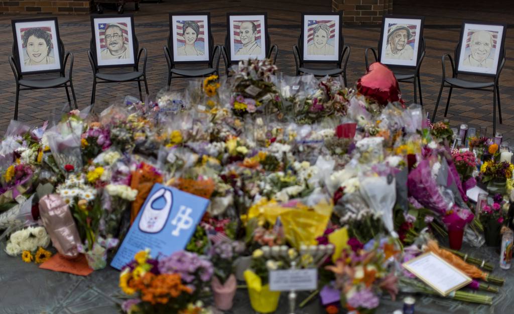 Pictures of the seven victims are displayed at memorial in Port Clinton Square on July 11, 2022, one week after a mass shooting at the Fourth of July parade in Highland Park.