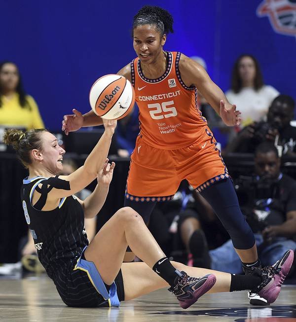 The Sky's Alanna Smith passes the ball past the Sun's Alyssa Thomas on May 25, 2023.