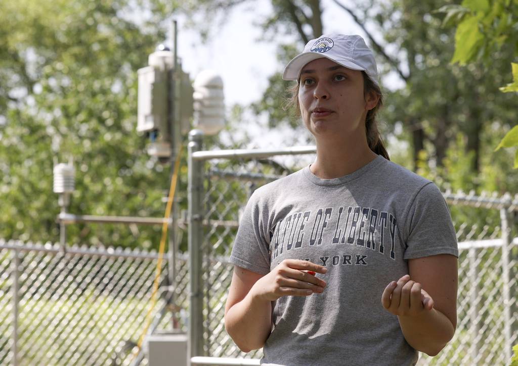Liz Wawrzyniak, a Northern Illinois University student, at a weather measurement station lab in Roseland on July 18, 2023.