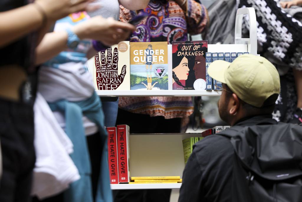 A person looks at the free banned books during the MoveOn “Banned Bookmobile” Tour stop outside of Sandmeyer’s Bookstore in the South Loop on July 13, 2023.