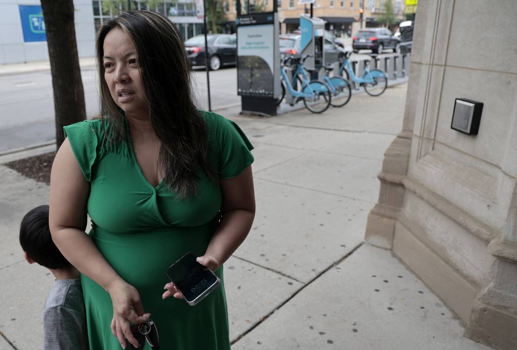 Quynh Hoang, a mother of three, talks about the possibility of sharing space with migrants, outside the Broadway Armory on July 26, 2023.