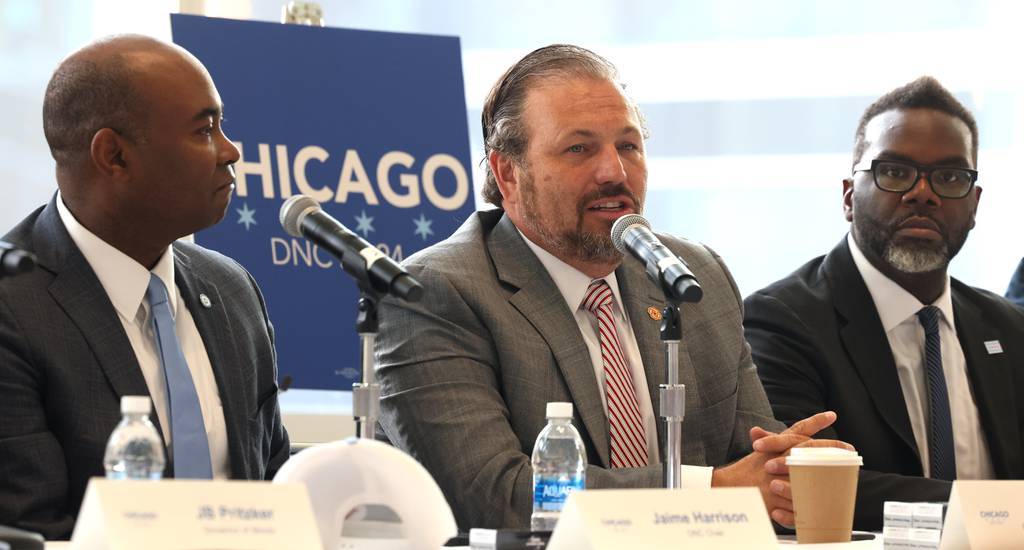 Chicago Federation of Labor President Bob Reiter, center, speaks as Democratic National Committee Chair Jaime Harrison, left, and Mayor Brandon Johnson listen along with labor leaders and Chicago stakeholders at McCormick Place West in Chicago on July 25, 2023.