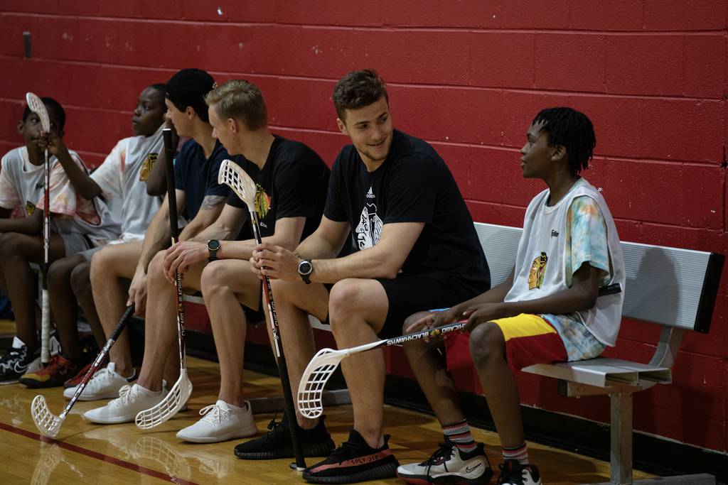 Marcel Marcel chats with Matthew as Blackhawks draft picks play floor hockey with kids from the James R. Jordan Boys and Girls Club on the Near West Side on Wednesday, July 5, 2023.