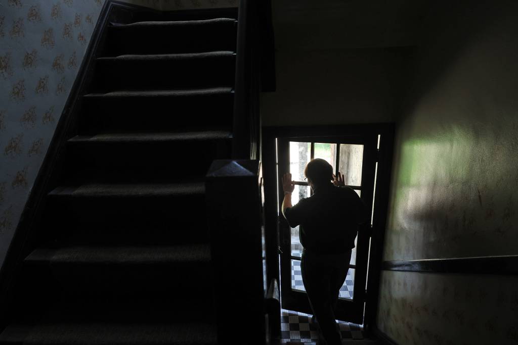 Gordon Dymowski opens the front entrance to his apartment building where he has lived for the past six years on July 19, 2023, in Chicago. “We’re on the front lines of gentrification,” Dymowski said.