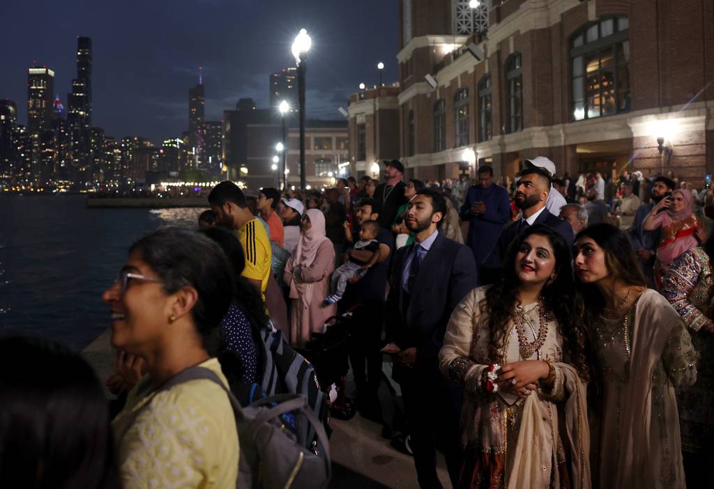 People watch from Navy Pier in Chicago as fireworks are set off on July 1, 2023, to celebrate the Fourth of July weekend.  