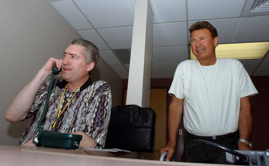 Pat Hughes, left, and Ron Santo get ready to call a spring training game in the WGN-AM 720 booth on Feb. 28, 2002, in Mesa, Ariz.