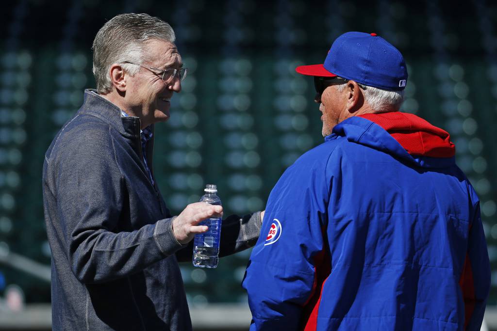 Cubs radio broadcaster Pat Hughes, left, chats with manager Joe Maddon during batting practice during spring training on March 5, 2015, in Mesa, Ariz.