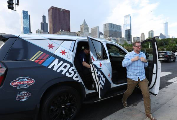 Race car driver Dale Earnhardt Jr. exits an SUV after viewing the course layout for the upcoming NASCAR race on May 31, 2023.
