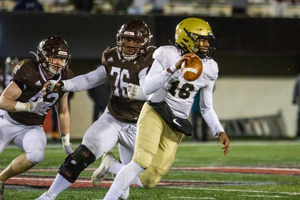 Joliet Catholic's Dillan Johnson (76) chases after Springfield Sacred Heart-Griffin quarterback Ty Lott during the Class 4A state championship game at Northern Illinois University in DeKalb on Friday, Nov. 26, 2021.